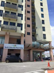 a car parked in front of a tall building at Residence-South China Sea Place by WinJ Management in Kota Kinabalu