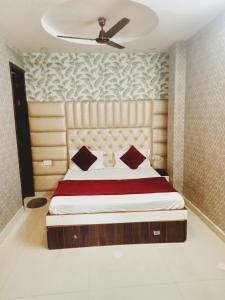 a bedroom with a bed with a wooden headboard at Hotel Robin Inn in Amritsar