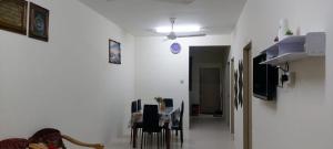 a dining room with a table and chairs in a room at Bambob Homestay and Car Rental in Gambang