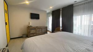 Postel nebo postele na pokoji v ubytování Fardo Hotel Autónomo en Bogotá - Zona T - Recepción Digital 24H