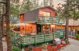 a house with a green deck and a red house at Sugar in the Raw Cabin - Hot Tub in Sugarloaf