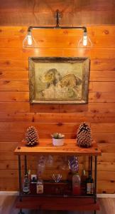 a painting of two birds on a wooden wall at Sugar in the Raw Cabin w AC - Hot Tub in Sugarloaf