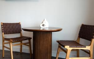 two chairs sitting next to a table with a vase on top at Hollywood Hills Hotel in Los Angeles