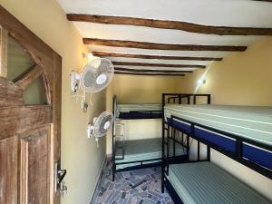 a room with bunk beds and a door at Terrapin village and hostel in Pwani Mchangani
