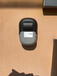 a black mailbox on the side of a building at Self Check-In Loft in Klaipeda city centre Free Parking in Klaipėda