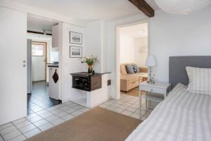 a bedroom with a bed and a living room at Swedish Farmhouse near Malmö and Copenhagen in Trelleborg