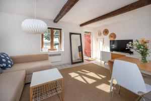 a living room with a couch and a tv at Swedish Farmhouse near Malmö and Copenhagen in Trelleborg