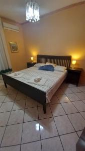 a bedroom with a large bed with two towels on it at Collina del Sole in Letojanni