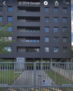 a tall building with a fence in front of it at Appartement Lille Europe in Lille