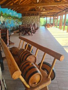 a wooden bench in a room with a painting at Casa Vlad in Murighiol