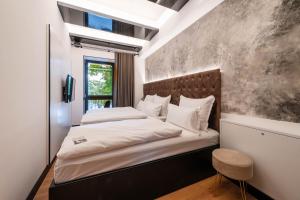 ein Schlafzimmer mit einem großen Bett mit einem braunen Kopfteil in der Unterkunft Hotel am Beatles-Platz in Hamburg