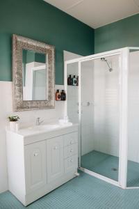 a bathroom with a white sink and a shower at The Westbury Dubbo in Dubbo