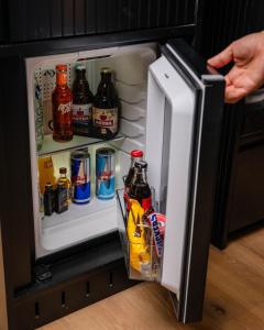 a person is reaching inside of an open refrigerator at Hotel am Beatles-Platz in Hamburg