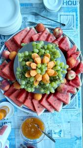 un plato de uvas y fruta en una mesa en Hotel Monica en Rímini