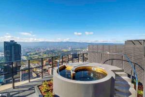 a balcony with a swimming pool on top of a building at Sky Apartment - Realm Adelaide in Adelaide