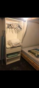 a room with a closet with a bed and a closetploadploadploadploadpload at T2 vue sur Ocean Indien in Saint-Leu