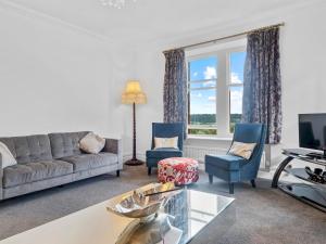 a living room with a couch and two chairs at Pass the Keys Olive Tree Lovely Apartment with Sea Views in Grange Over Sands