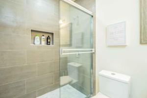 a bathroom with a glass shower with a toilet at 2B2B New Remodel King Bed in Altadena
