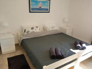 a bedroom with a bed with brown shoes on it at Apartment Patrik in Vabriga +37 photos