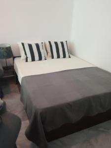 a bedroom with two beds with black and white pillows at Beautiful location apartment in Sofia