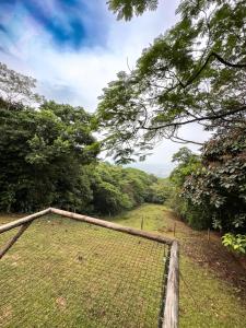 a fence in the middle of a field with trees at Glamping Itawa & Ecoparque turístico in Villavicencio