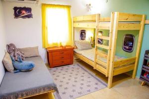 a bedroom with two bunk beds and a window at זמן מדבר in Mitzpe Ramon