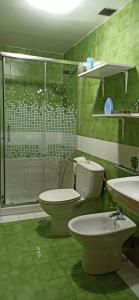 a bathroom with two toilets and a glass shower at Casa Daila in Costa de Antigua +10 photos