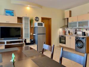 a kitchen with a table and a dining room at Premium Apartment Midia Beach in Sunny Beach
