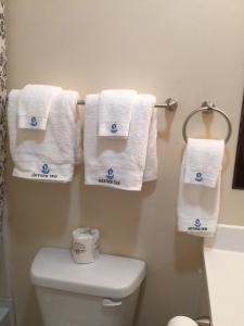 a bathroom with white towels hanging on a towel rack at Geyser Inn in West Yellowstone +10 photos