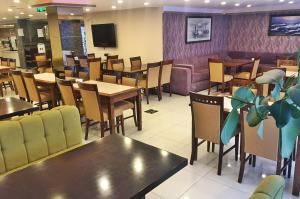 a restaurant with tables and chairs and a couch at Hotel Süreyya in Istanbul