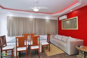 a living room with a couch and a table and chairs at Linda cobertura com jaccuzzi e terraço in Rio de Janeiro