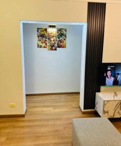 a room with a white wall with pictures on it at شقه مفروش الترا سوبر لوكس مدينتى in Madinaty