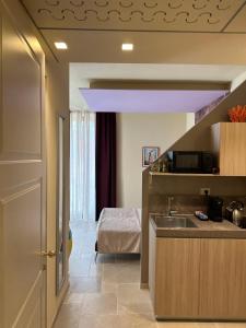 a kitchen with a sink and a bed in a room at Iris apartments in Monopoli