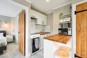 a small kitchen with a sink and a stove at Garden Flat, Walnut Tree House in Rustington +7 photos