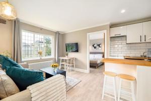 a living room with a couch and a table at Garden Flat, Walnut Tree House in Rustington