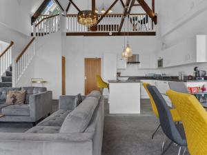 a living room with a couch and chairs and a kitchen at Pass the Keys Yew Tree Stunning Apartment with Sea View in Grange Over Sands
