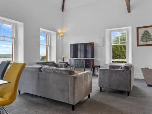 a living room with two couches and a flat screen tv at Pass the Keys Yew Tree Stunning Apartment with Sea View in Grange Over Sands