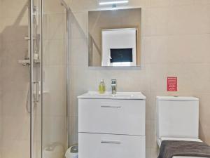 a bathroom with a toilet and a sink and a shower at Pass the Keys Yew Tree Stunning Apartment with Sea View in Grange Over Sands