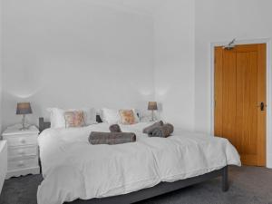 a bedroom with a white bed with two pillows on it at Pass the Keys Yew Tree Stunning Apartment with Sea View in Grange Over Sands