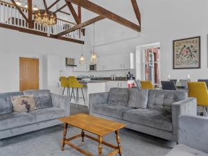 a living room with two couches and a table at Pass the Keys Yew Tree Stunning Apartment with Sea View in Grange Over Sands