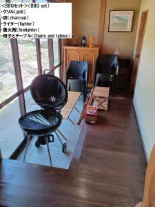 a living room with a chair and a table at 【１棟貸切宿】木曽家旅館〜しまなみ海道最初の島〜 in Onomichi