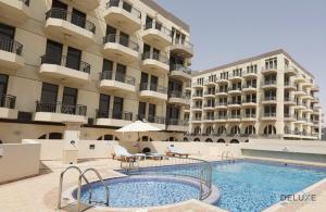 a swimming pool in front of a building at Elegant Studio at DAMAC Lincoln Park A Arjan-Dubailand by Deluxe Holiday Homes in Dubai