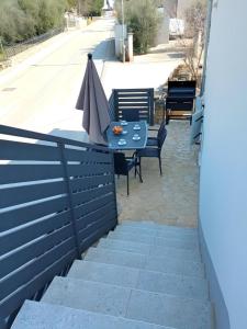 a blue table with an umbrella on a patio at Apartment Valentino in Vabriga