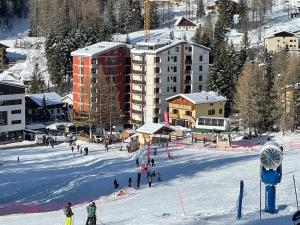 a group of people skiing on a snow covered slope at Appartamento Kern-Sciare A Portata Di Mano- in Madesimo