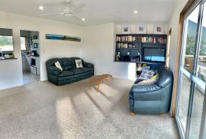 a living room with two couches and a tv at Tranquil Retreat - Spacious Home for a Relaxing Getaway 