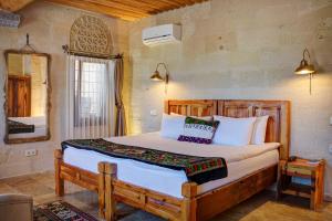 a bedroom with a large bed in a room at Petra Inn Cappadocia in Uchisar