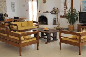 a living room with wooden furniture and a fireplace at Eri Hotel in Parikia
