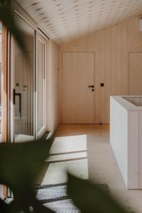 an empty room with a white counter and a door at ATTO Apartments in San Candido