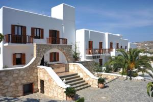 a villa with a staircase in front of a building at Eri Hotel in Parikia