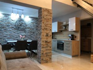 a kitchen and dining room with a stone wall at Ulika Novalja in Novalja